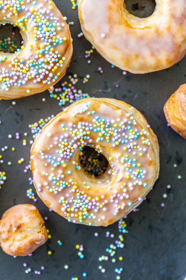 Glazed donuts with sprinkles on a serving tray