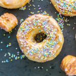 Glazed donuts with sprinkles on a serving tray