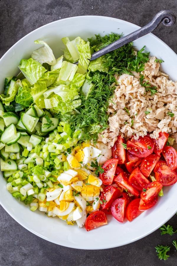 Cobb Salad with Tuna in a bowl with spoon 