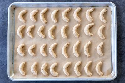 crescent cookies on a baking sheet