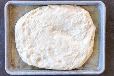 Focaccia dough on a baking pan