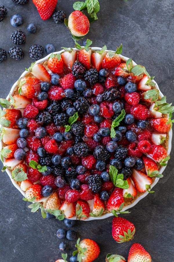 Fruit tart with berries around it 