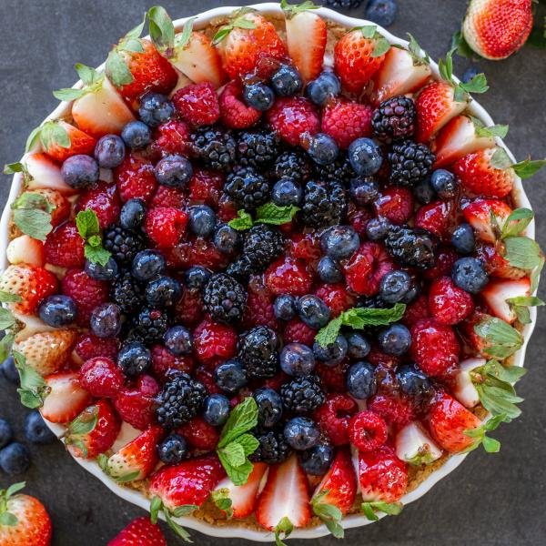 Fruit tart with berries around it