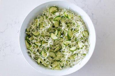 Seasoning and dressing added to the cabbage salad