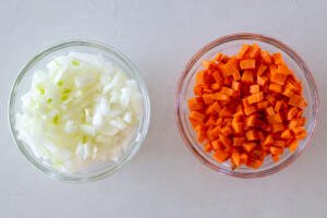 onion and carrots chopped in a bowls