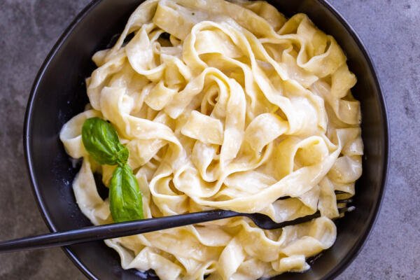 Bowl of pasta with alfredo in a bowl