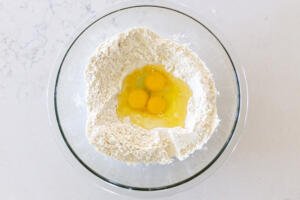 flour with eggs in a bowl
