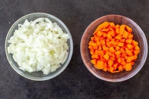 Chopped carrot and onion in bowls