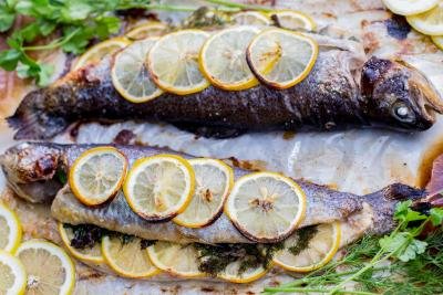 Baked herb lemon trout on a tray.