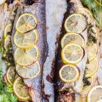 Baked herb lemon trout on a tray.