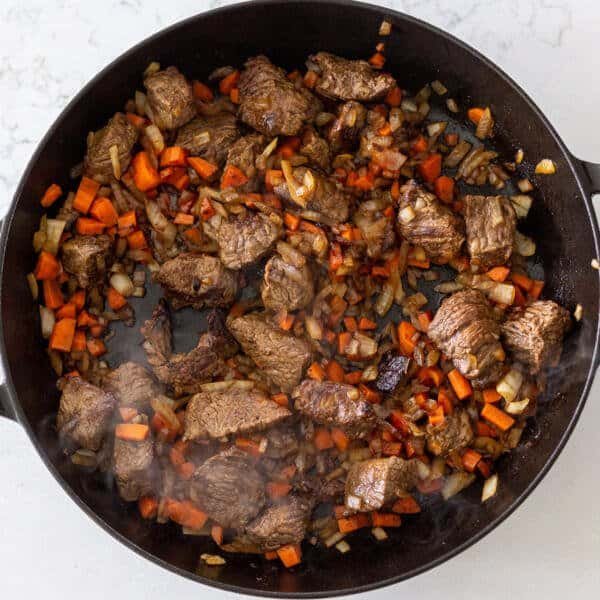 cooked veggies and beef in a pan
