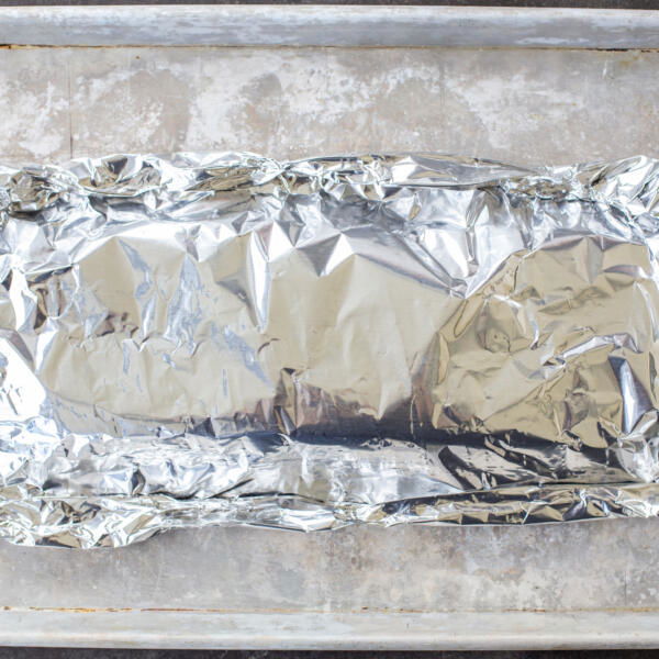 Pork BBQ ribs wrapped in foil.