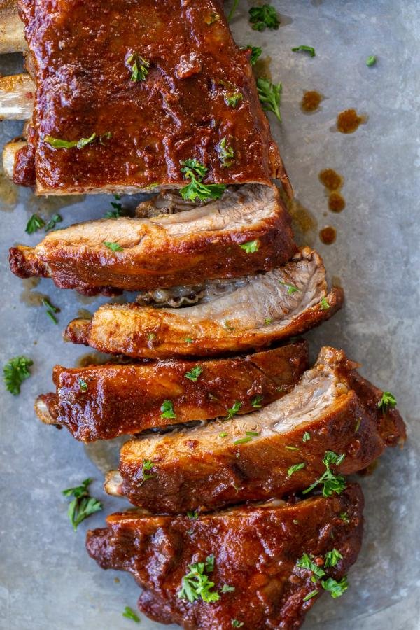 Baked BBQ ribs with herbs on a pan. 