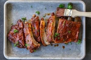 Baked BBQ pork on a pan with herbs.