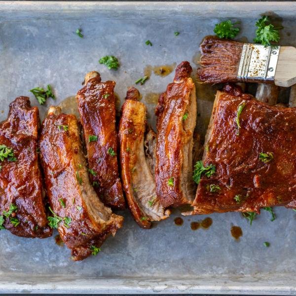 Baked BBQ pork on a pan with herbs.