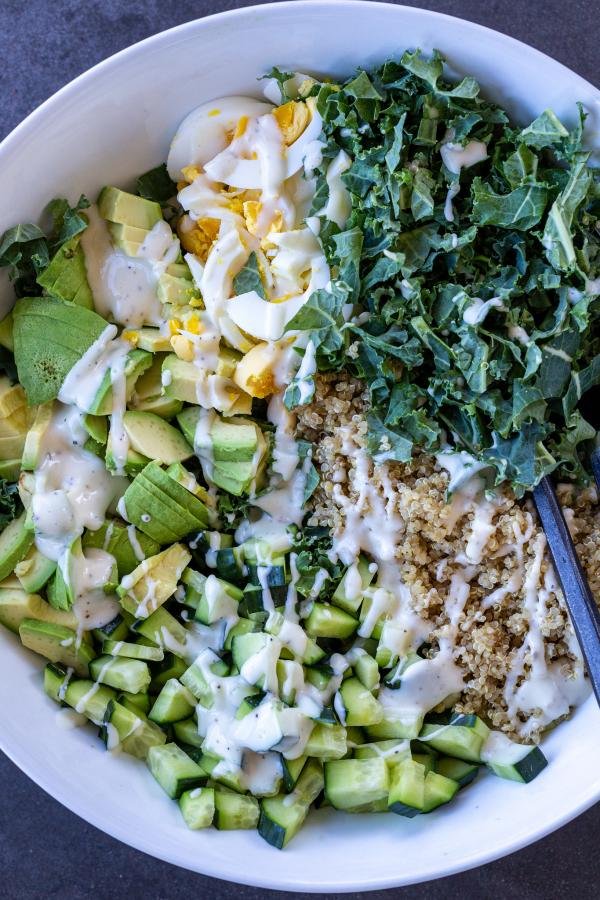 Quinoa Kale and Avocado Salad with dressing on top