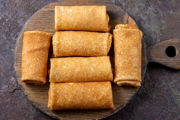 Blintzes with filling on a serving tray