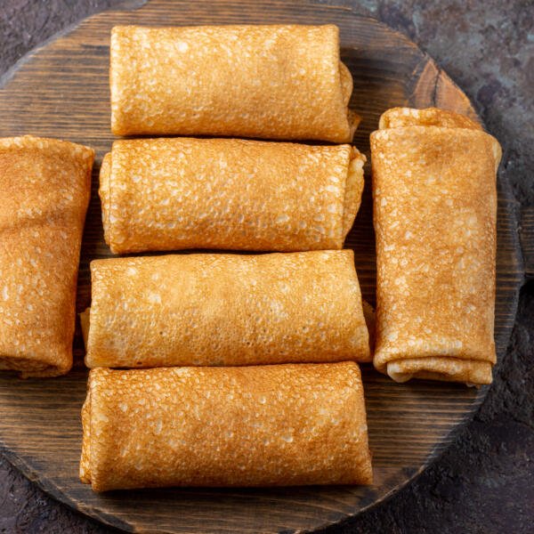Blintzes with filling on a serving tray