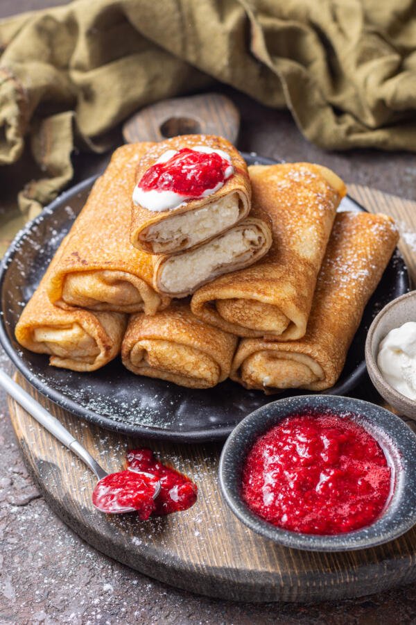 Sweet Cheese Blintzes on a plate with toppings