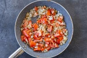 onion and tomatoes in a pan