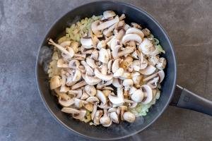 Mushrooms and onion in a pan
