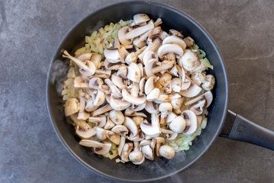 Mushrooms and onion in a pan