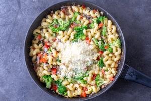 Creamy Veggie Pasta in pan with parmesan cheese