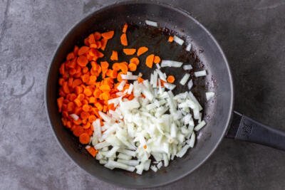 Cooked onion and carrot in a pan
