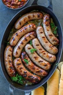 Beer Bratwurst in a pan with onions.
