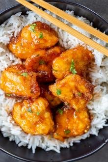 Sweet and sour chicken in a pan with rice