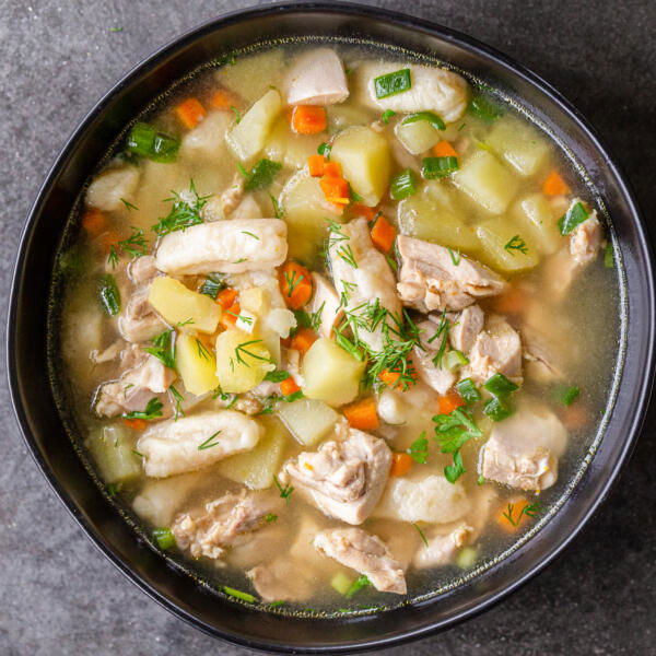 Chicken dumpling soup in a bowl.