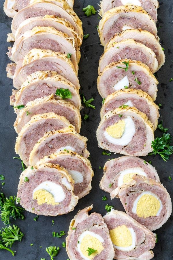 Chicken Roulade on a serving tray with herbs