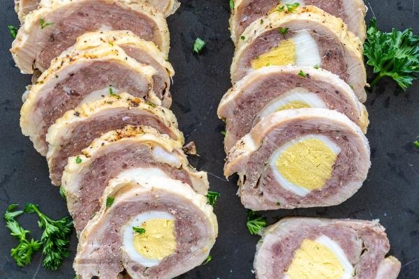 Chicken Roulade on a serving tray with herbs