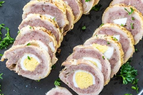 Chicken Roulade on a serving tray with herbs