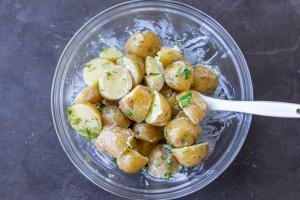 Creamed potatoes in a bowl with herbs.