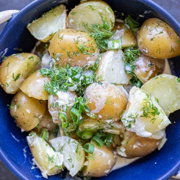 Creamed potatoes in a bowl with herbs.