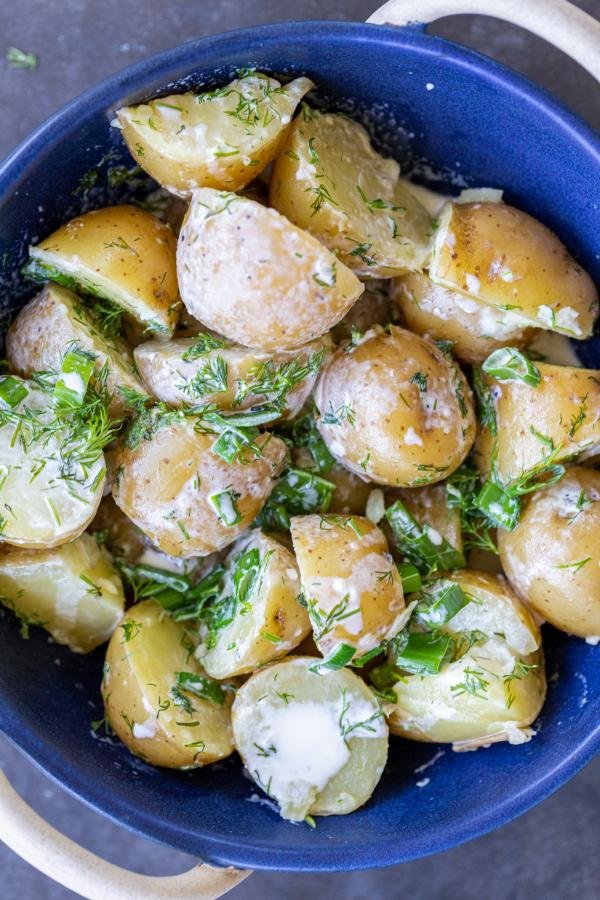 Creamed potatoes in a bowl with herbs. 