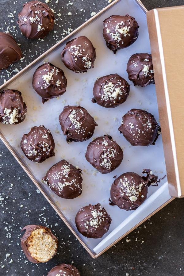 Chocolate dipped cheesecake bites in a box