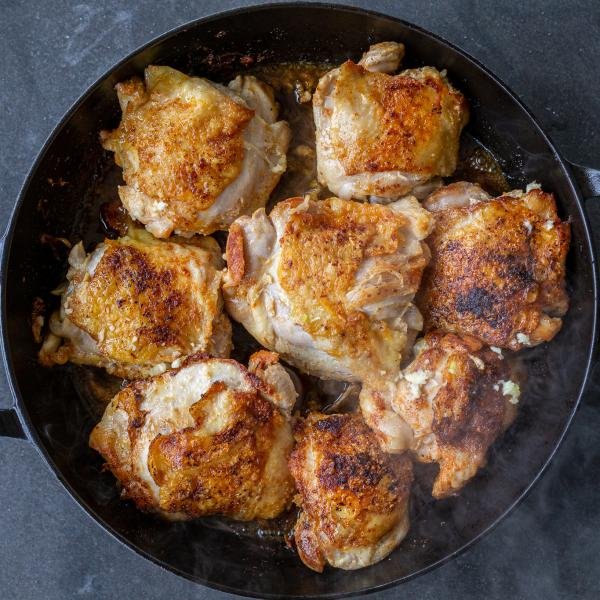 Chicken with garlic broth in a pan