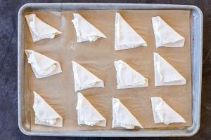 Sweet cheese turnovers on a baking pan