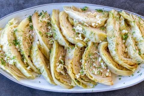 Cabbage with seasoning on a plate and herbs