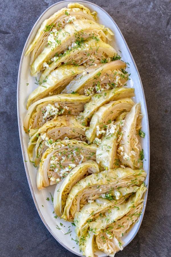 Cabbage with seasoning on a plate and herbs