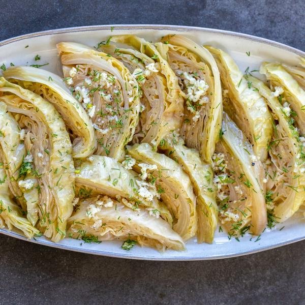 Cabbage with seasoning on a plate and herbs