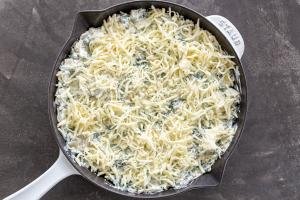 Spinach dip in a pan with cheese