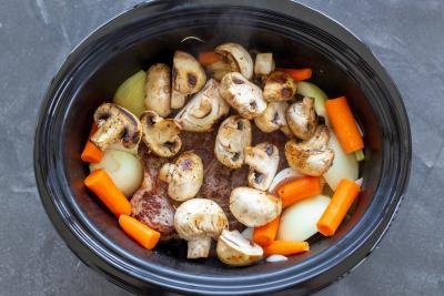 Mushrooms added to slow cooker beef.