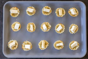 Phyllo shell with brie in a baking sheet.