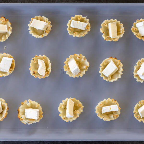 Phyllo shell with brie in a baking sheet.
