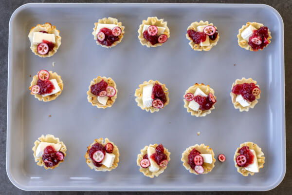Phyllo shells with brie, cranberry sauce and cranberries.