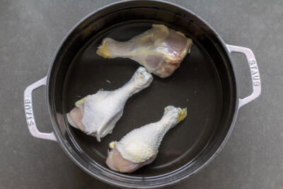 Chicken in a pot with water.