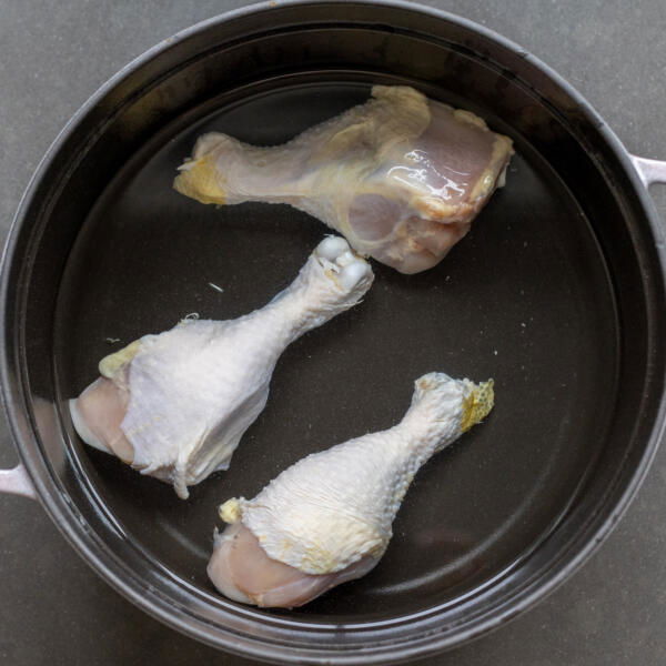 Chicken in a pot with water.